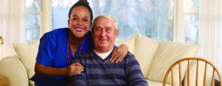 Nurse and elderly man smiling